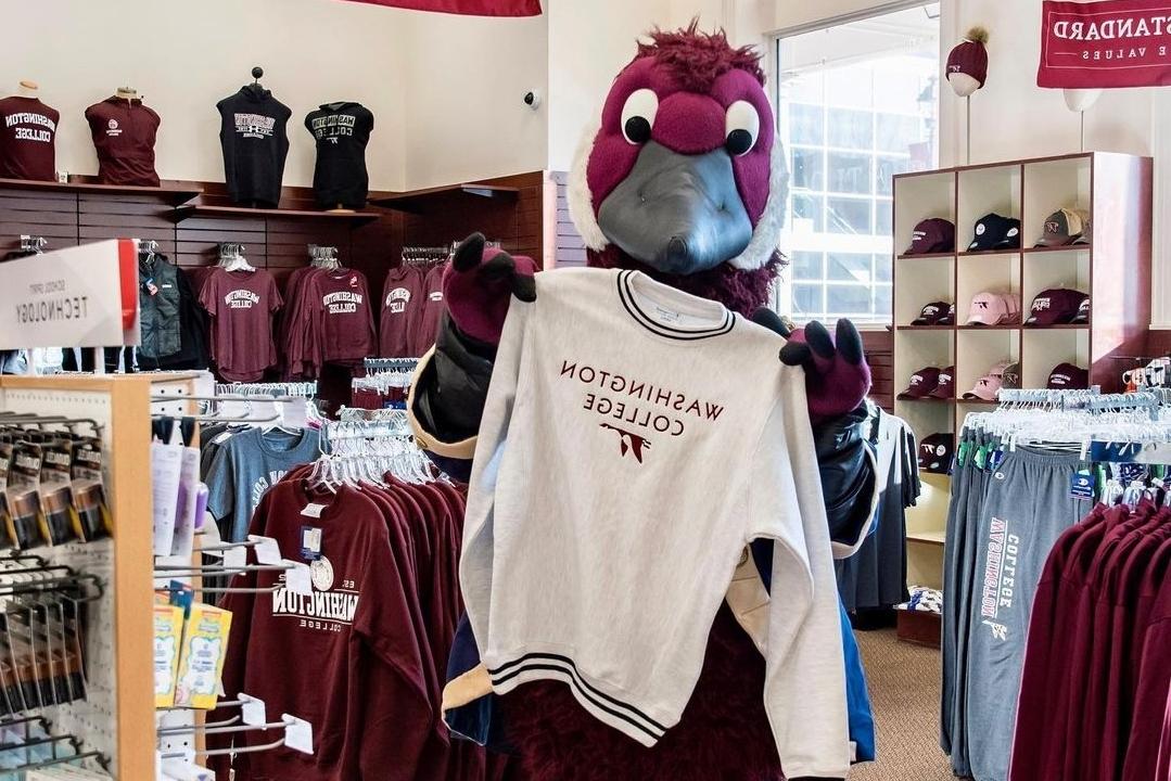 Gus the Goose Mascot holding a Washington College Sweatshirt